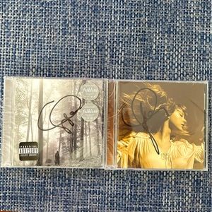 Autographed Taylor Swift Fearless and Folklore CDs